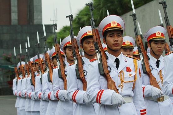 Flag salute at windy Ba Dinh Square